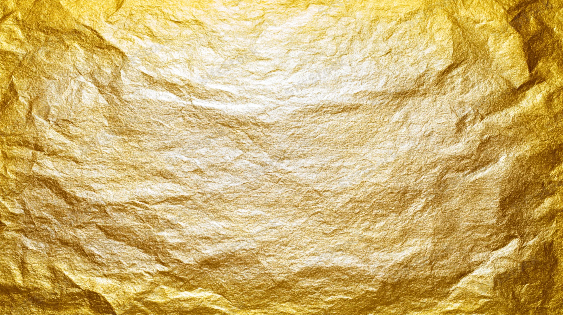 Crumpled gold foil sheet filling the frame as a textured background