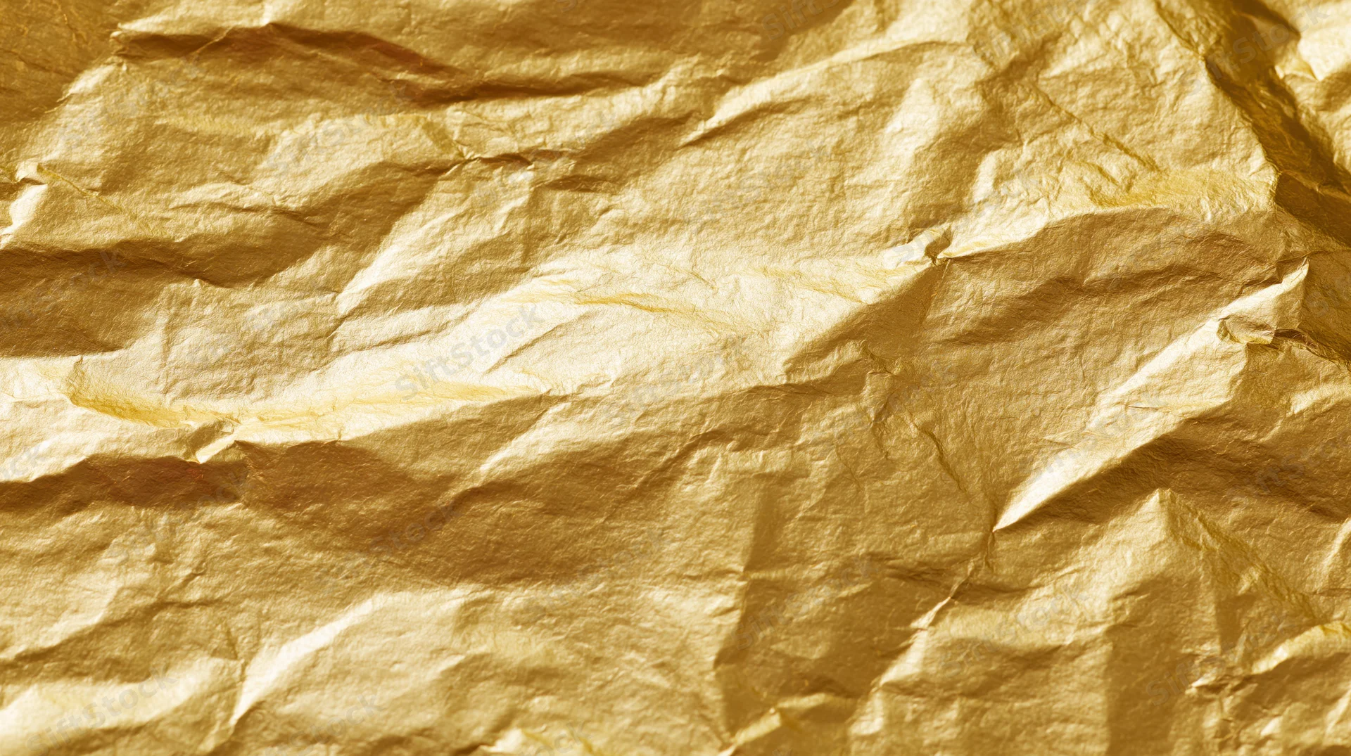 Crumpled gold foil sheet filling the frame as a textured background