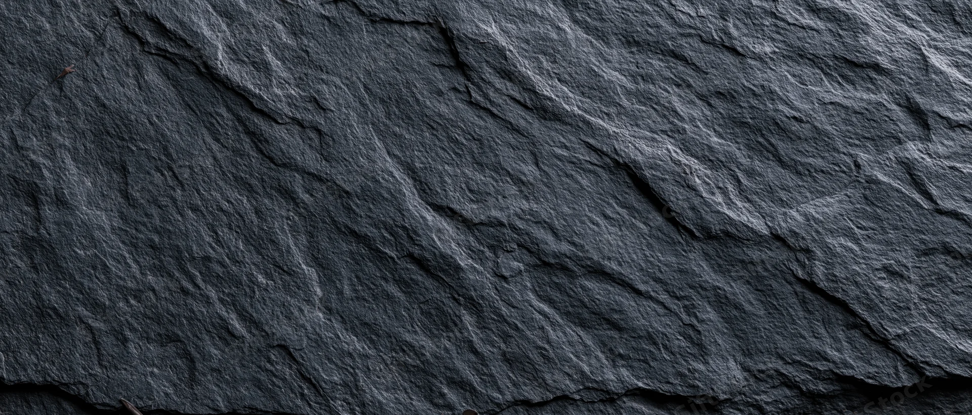 Dark textured slate surface filling the frame