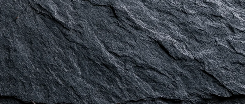 Dark textured slate surface filling the frame