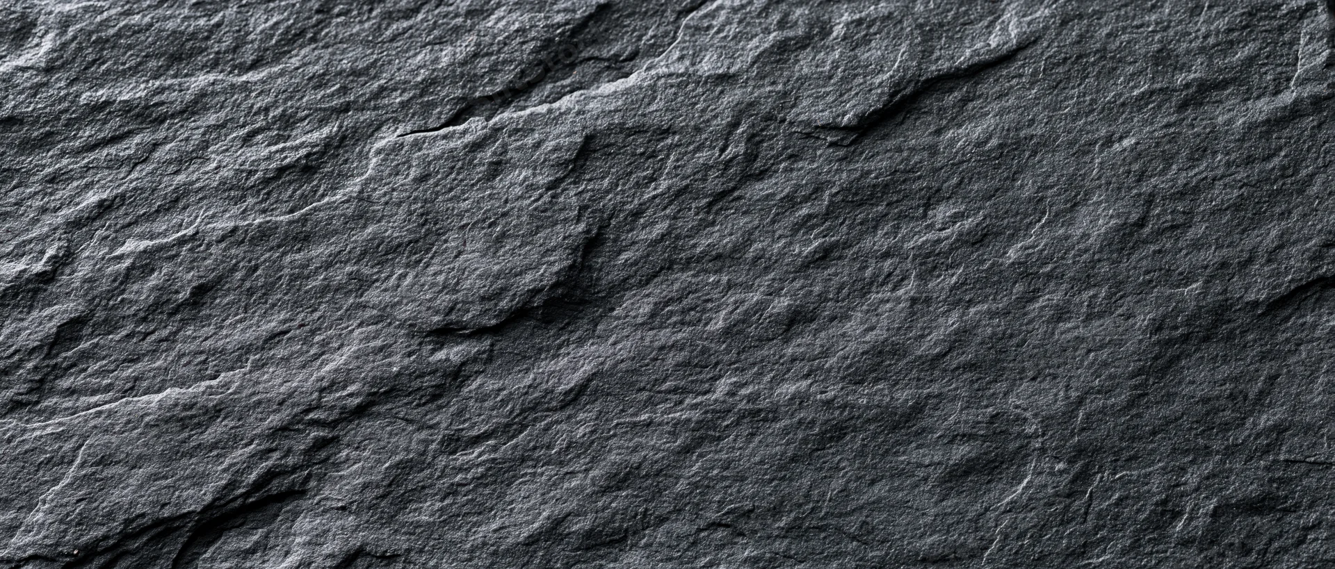 Dark textured slate surface filling the frame