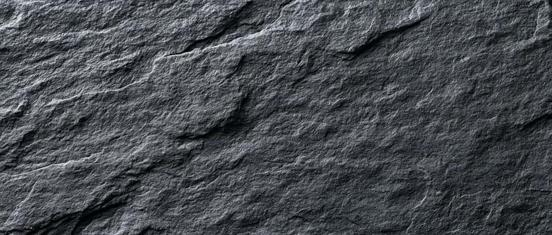 Dark textured slate surface filling the frame