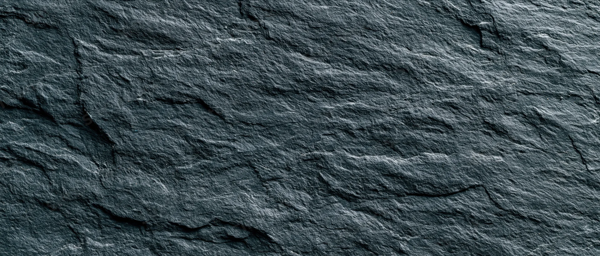 Dark textured slate surface filling the frame