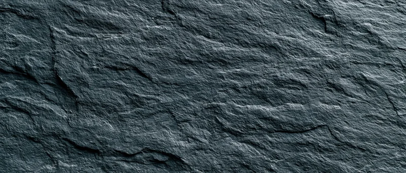 Dark textured slate surface filling the frame