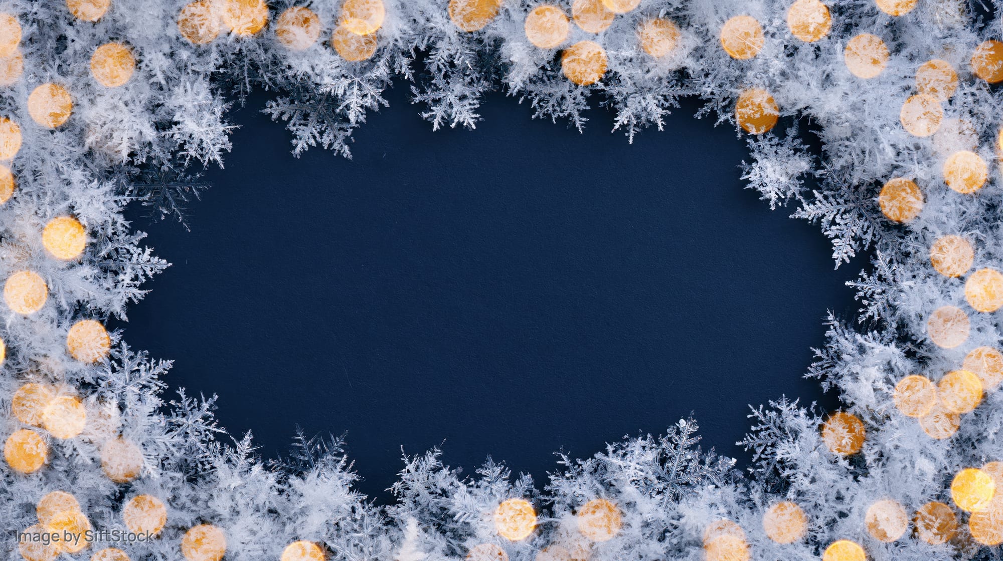 Frosty snowflake border with golden bokeh lights framing a dark blue center