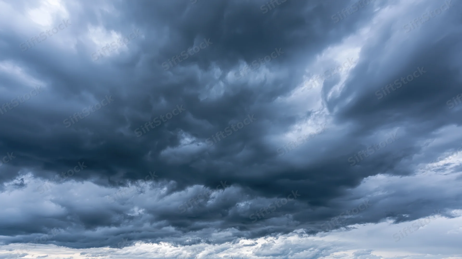 Dark cumulonimbus clouds filling the sky in a dramatic stormy formation