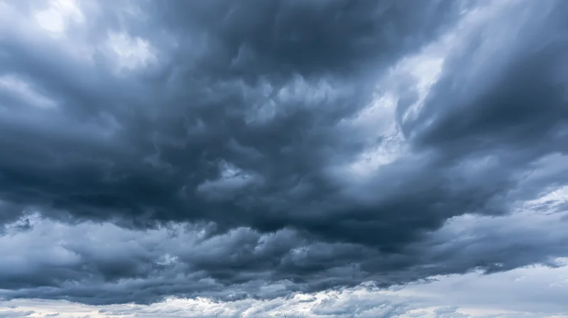 Dark cumulonimbus clouds filling the sky in a dramatic stormy formation