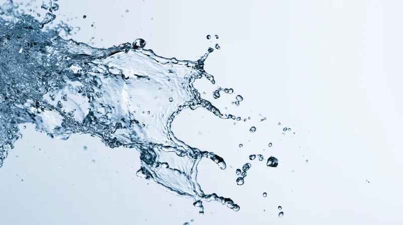 Dynamic water splash frozen mid-motion against a clean white background