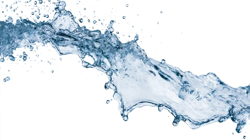 Dynamic water splash frozen mid-motion against clean white background