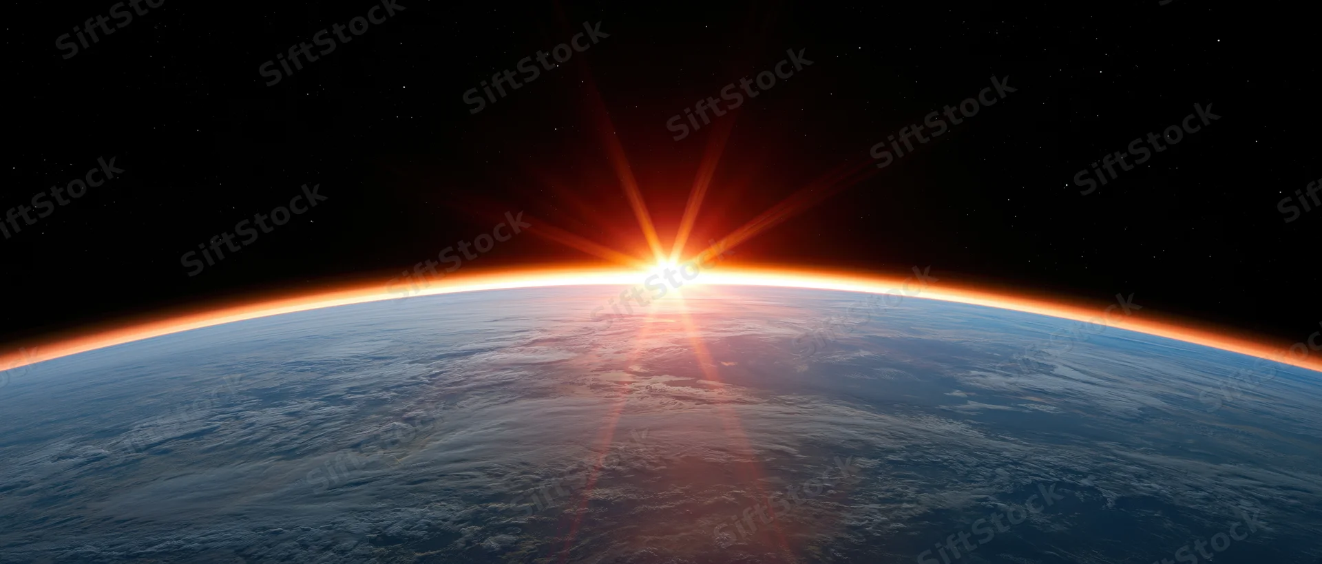 Earth's curved horizon from low orbit with sun rising directly over the planet's edge