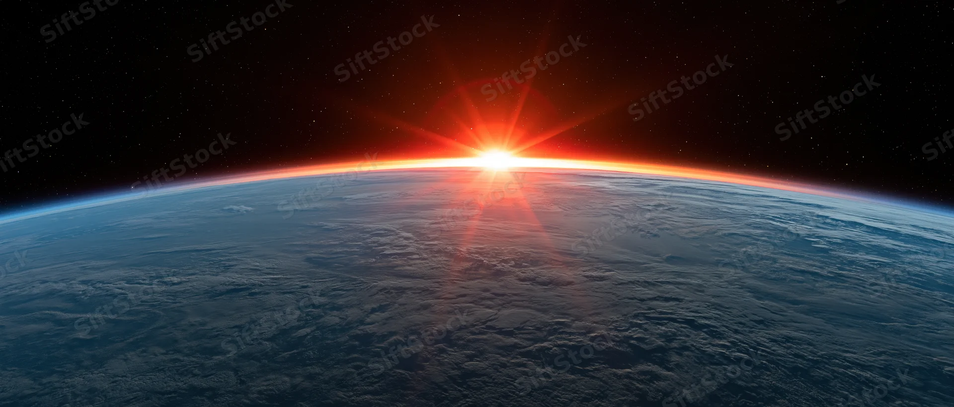Earth's curved horizon from low orbit with sun rising over the planet's edge