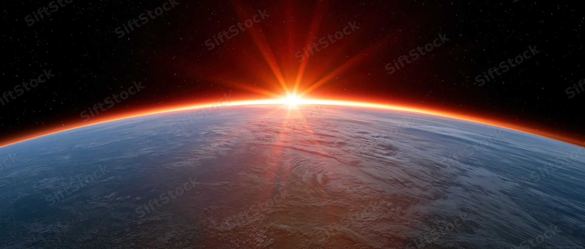 Earths curved horizon from low orbit with sun rising directly over the planet