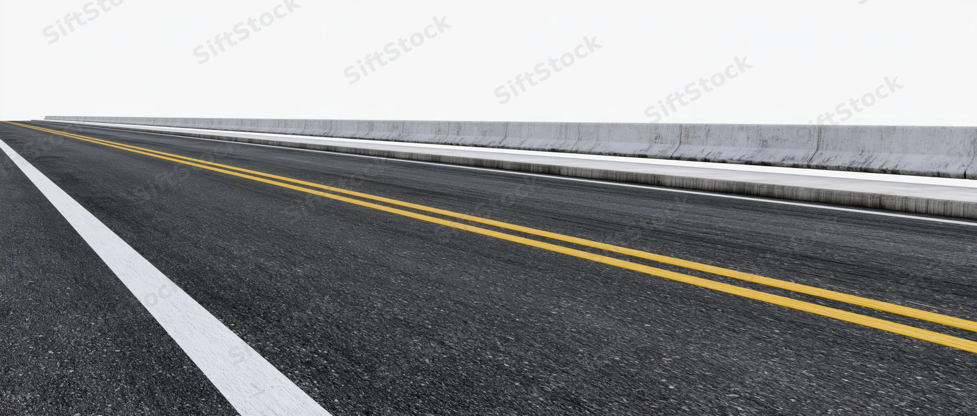 Empty two-lane asphalt road with double yellow and white lines viewed from ground level alongside concrete barrier
