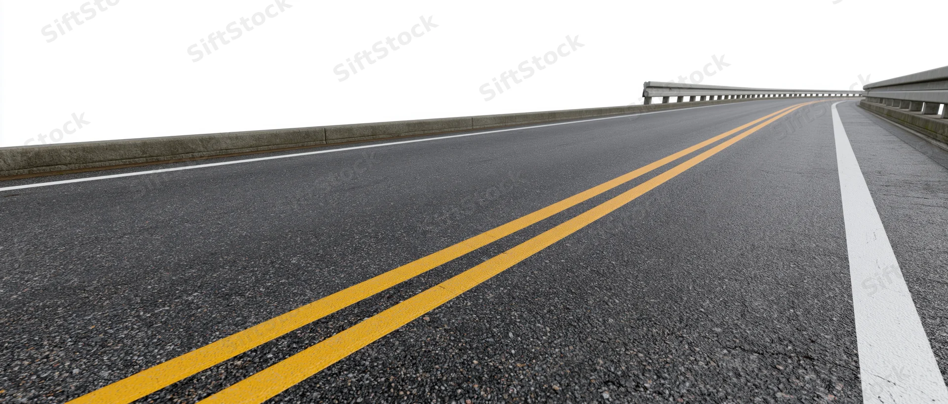 Empty two-lane asphalt road with double yellow lines and guardrails viewed from ground level