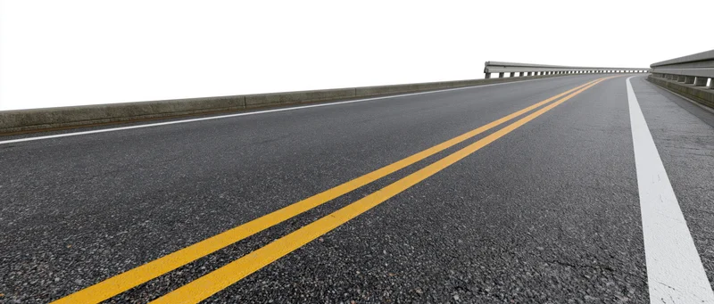 Empty two-lane asphalt road with double yellow lines and guardrails viewed from ground level