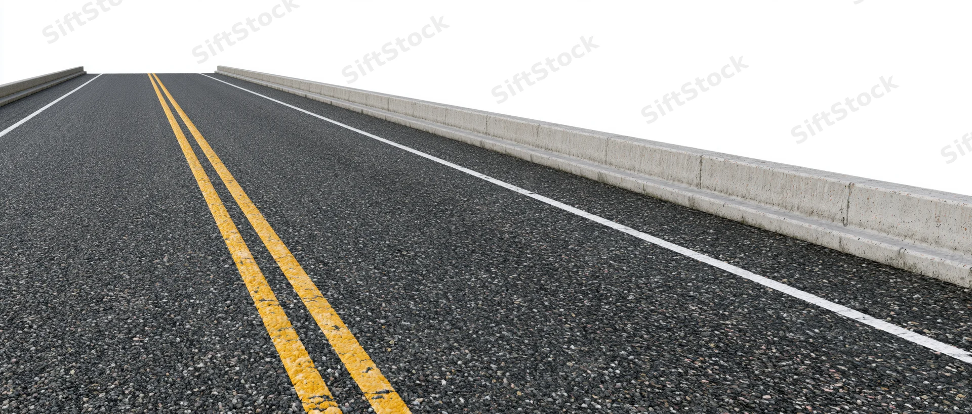 Empty asphalt road with double yellow line and concrete barrier, side view from ground level