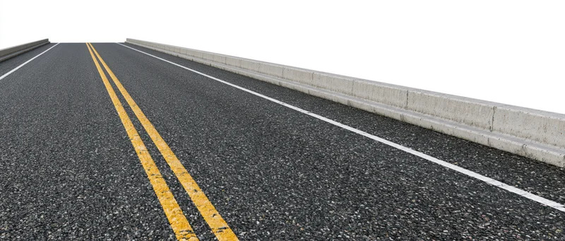 Empty asphalt road with double yellow line and concrete barrier, side view from ground level