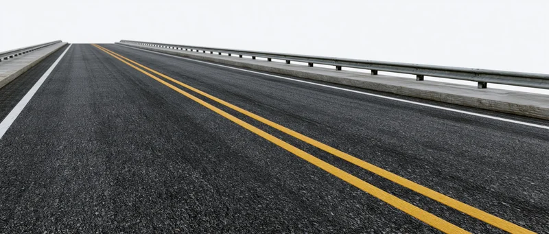 Empty two-lane asphalt road stretching into the distance on a bridge with guardrails and double yellow center line