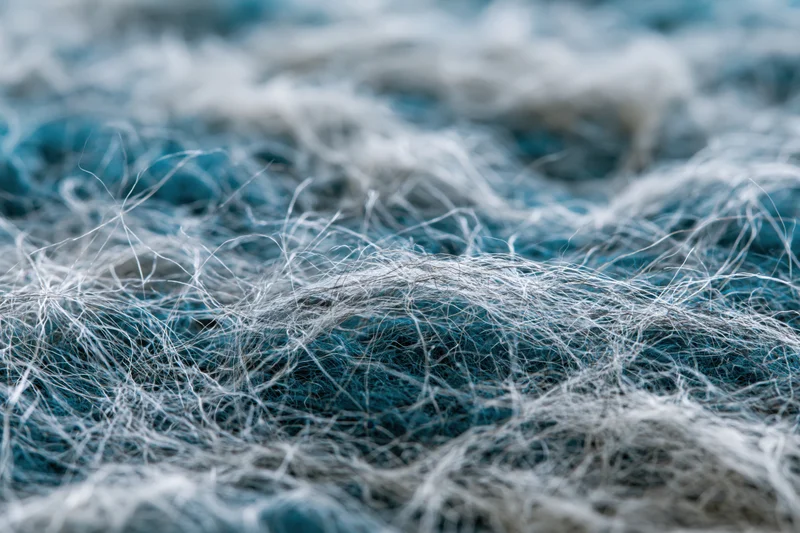 Close-up of tangled wool fibers in blue and white tones