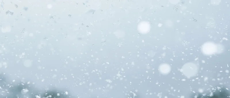 Falling snowflakes and soft bokeh particles in a winter sky