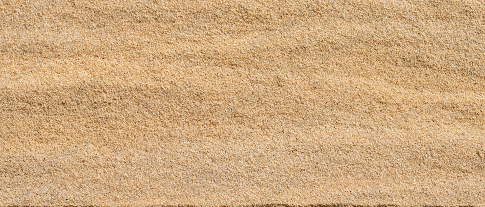 Closeup of fine dry beach sand surface filling the frame