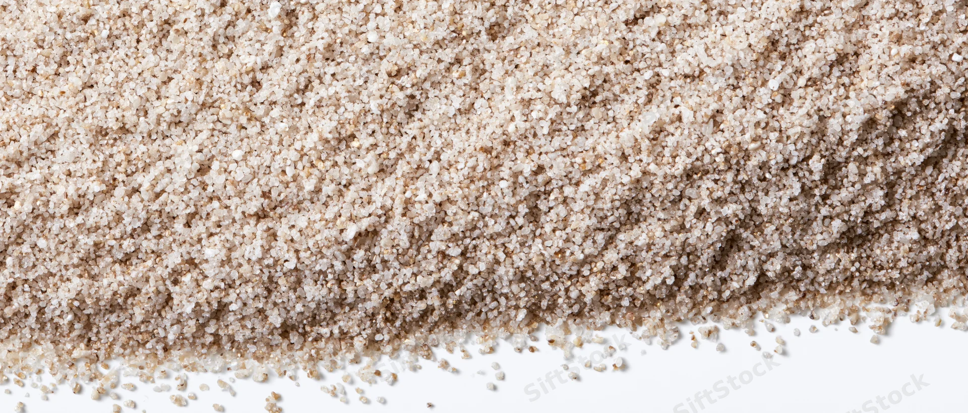 Fine dry sand granules spread across the upper frame tapering to a white background