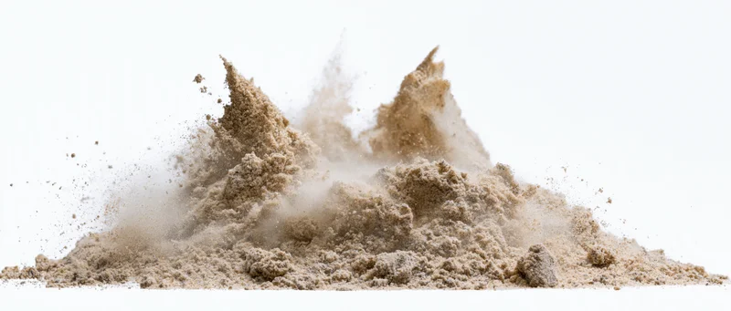 Fine dry sand mid-explosion burst frozen in motion against white background