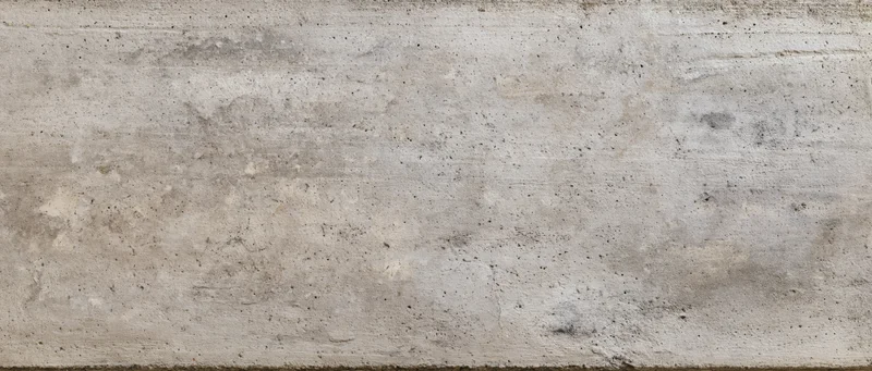 Flat concrete wall surface filling the frame with horizontal texture and weathered marks