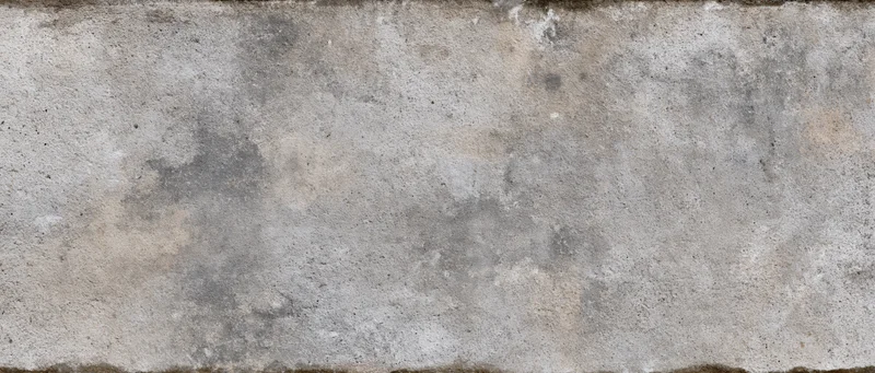 Weathered concrete wall surface filling the frame with visible texture and stains