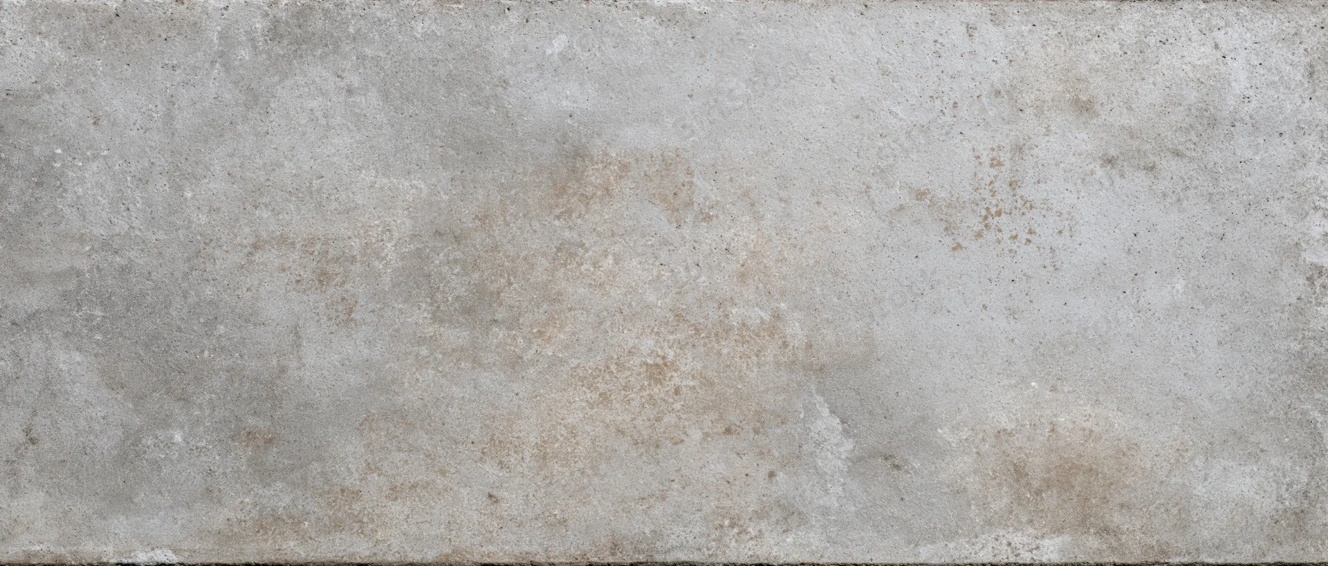 Close-up of a weathered concrete wall surface with natural stains and rough texture
