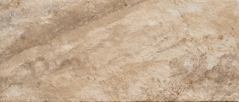 Weathered stone surface with natural texture and earthy tones for interior or exterior design