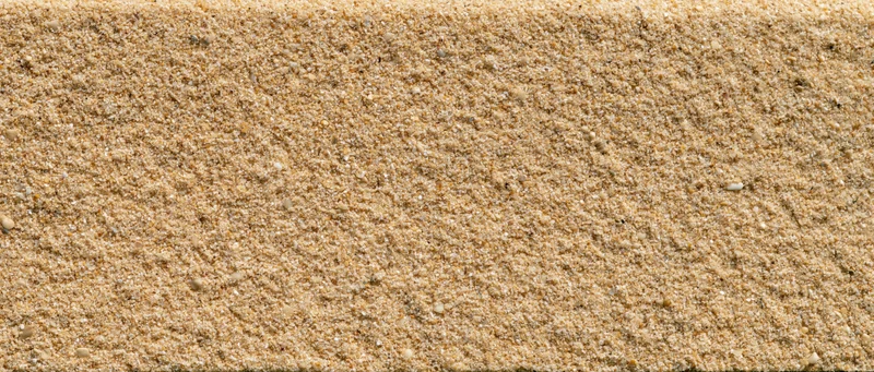 Close-up of smooth beach sand surface filling the frame