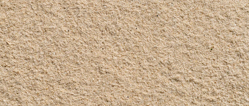 Close-up of smooth beach sand surface filling the frame