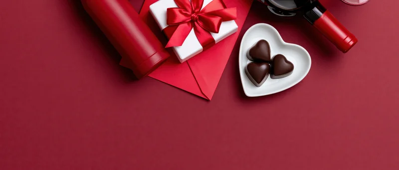 Valentines day items arranged in upper right corner on red surface