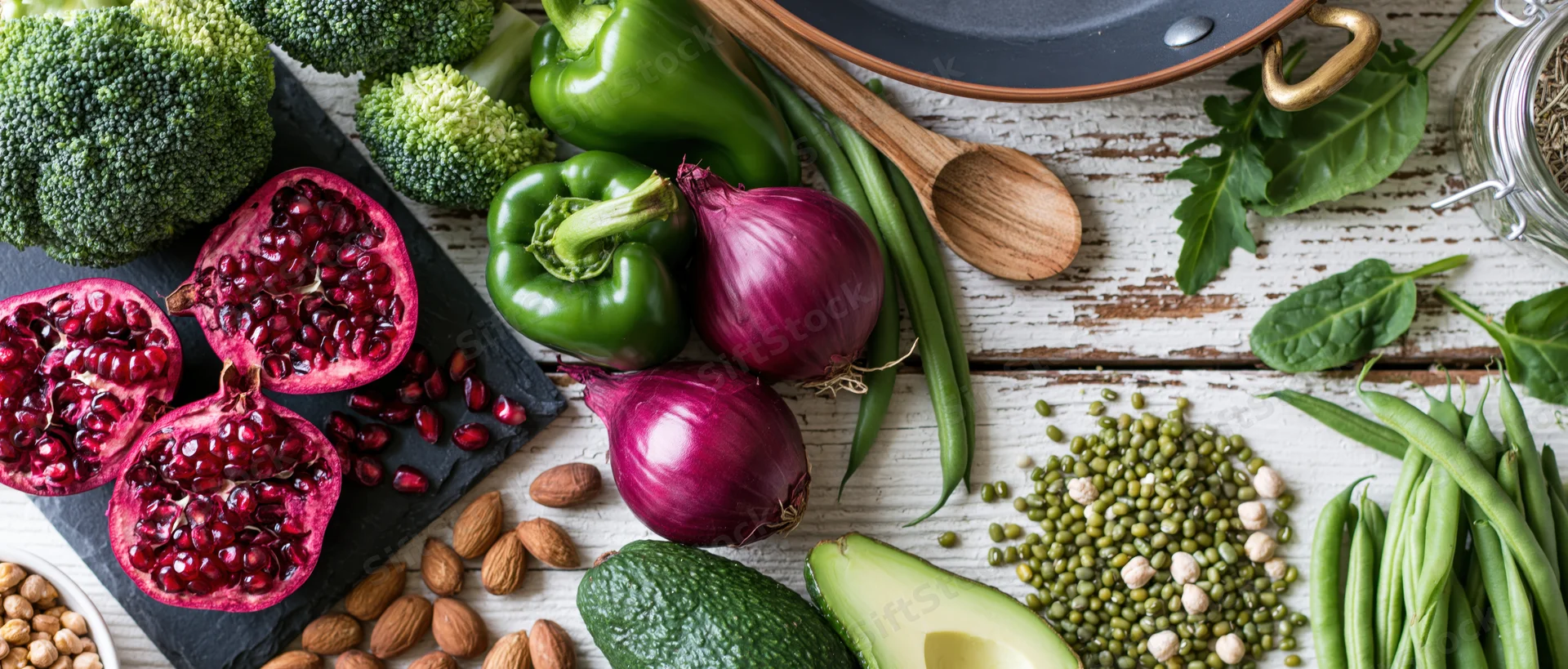 Fresh vegetables and fruits arranged with whole foods on a rustic wooden surface in a flat lay composition