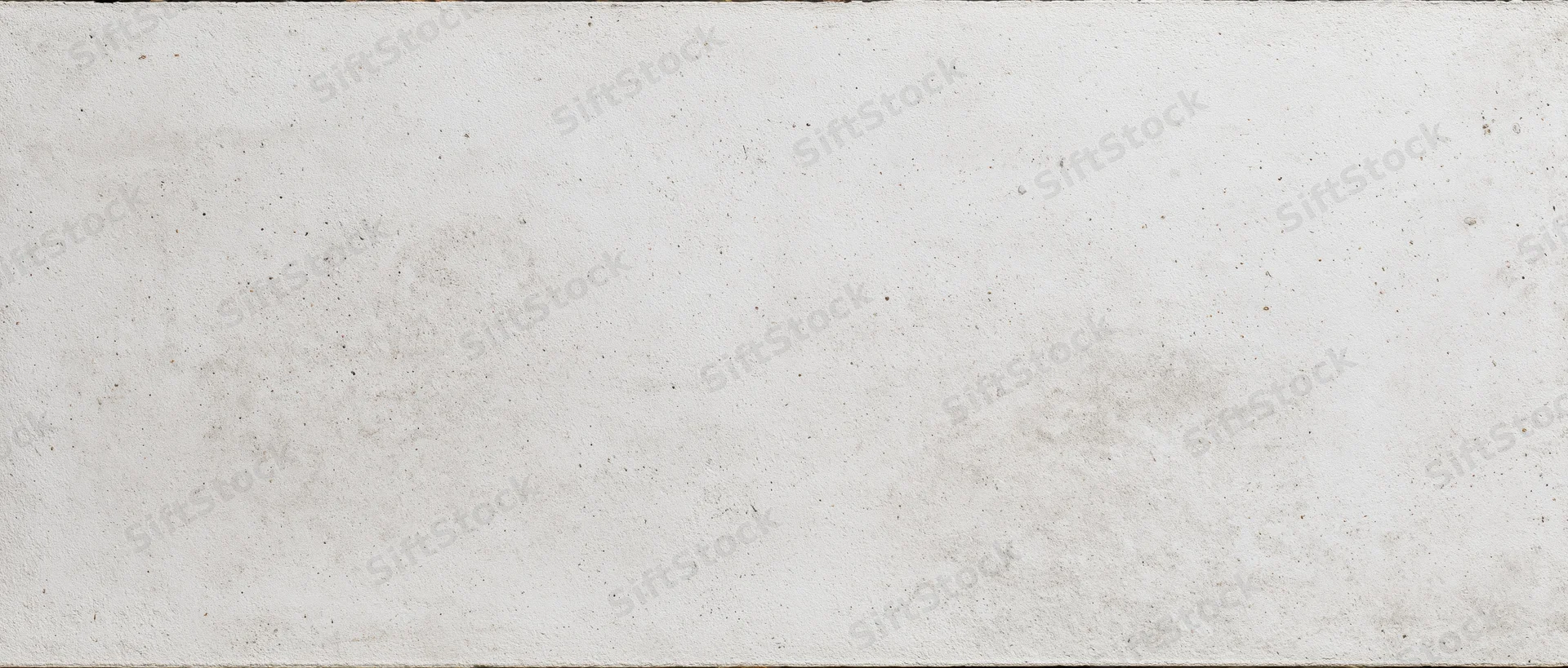 Close-up of a smooth gray concrete wall with subtle texture and minor imperfections
