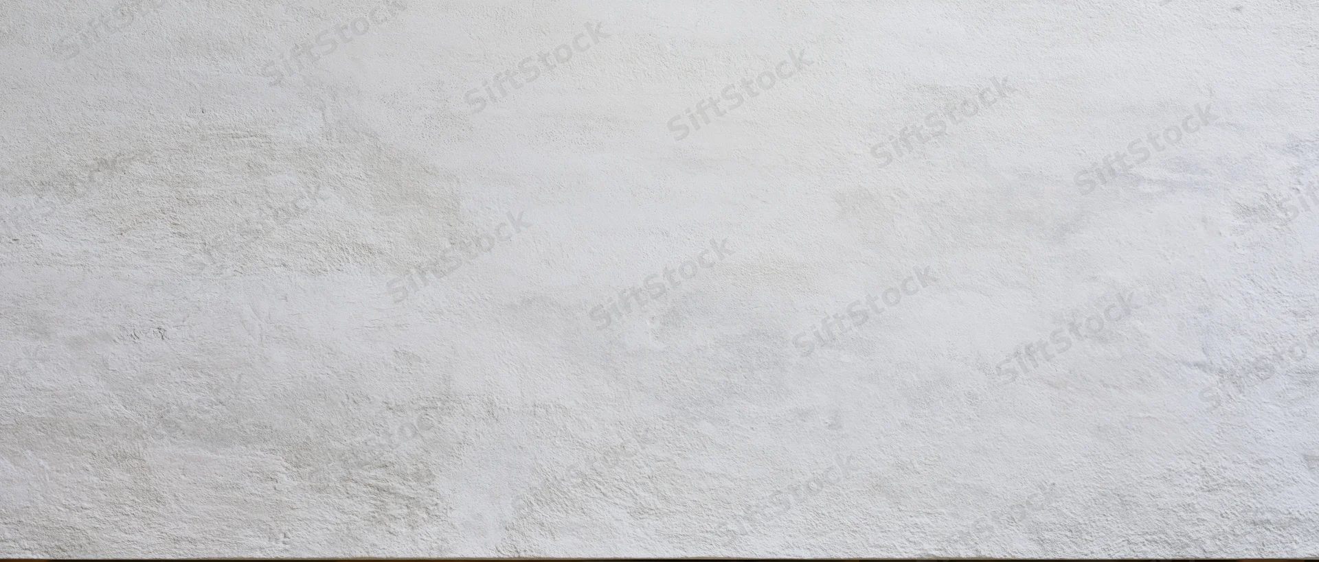 Smooth concrete wall surface with subtle texture and even lighting