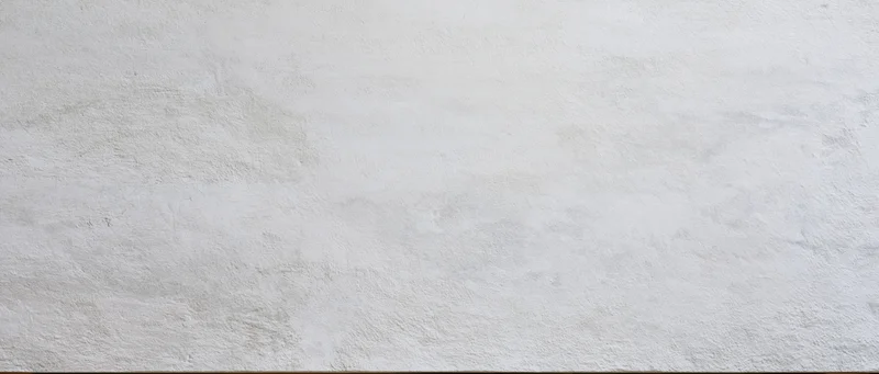 Smooth concrete wall surface with subtle texture and even lighting