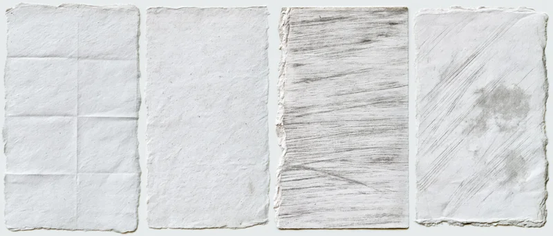 Four aged paper texture swatches arranged side by side on white background