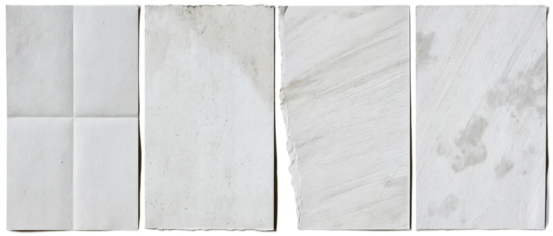 Four aged paper texture swatches arranged side by side on white background