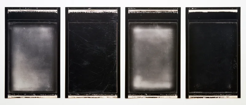 Four black film negative frames arranged side by side on a white background