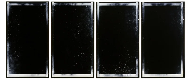 Four black film negative frames arranged side by side in a horizontal strip