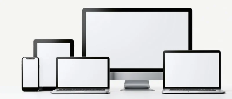 Multiple blank-screen devices arranged in a row on a white surface