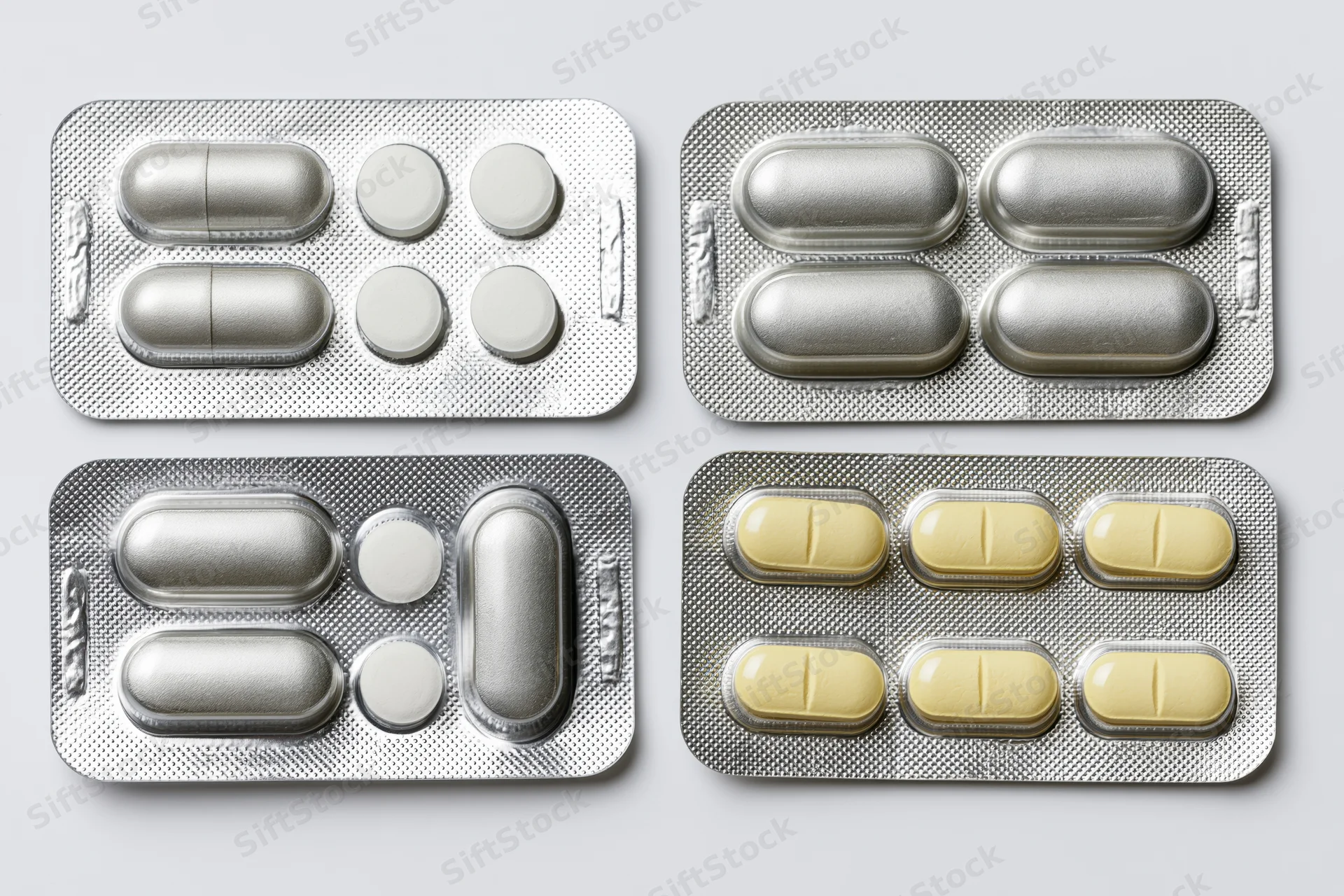 Four pharmaceutical blister packs arranged in a two-by-two grid on white background