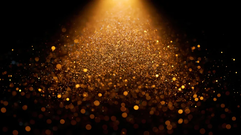Golden dust particles floating in a beam of light against a dark background