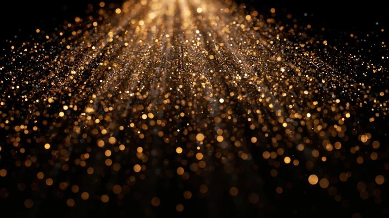 Golden dust particles floating and falling in a radiant bokeh effect against black background
