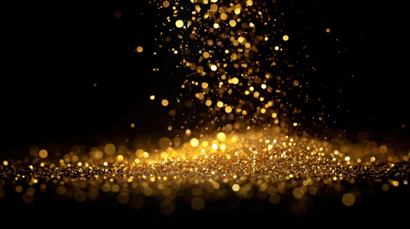 Golden glitter particles floating and falling against a dark background with bokeh lights and soft focus
