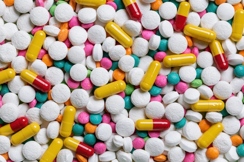 Assorted pharmaceutical pills and capsules in close-up overhead view