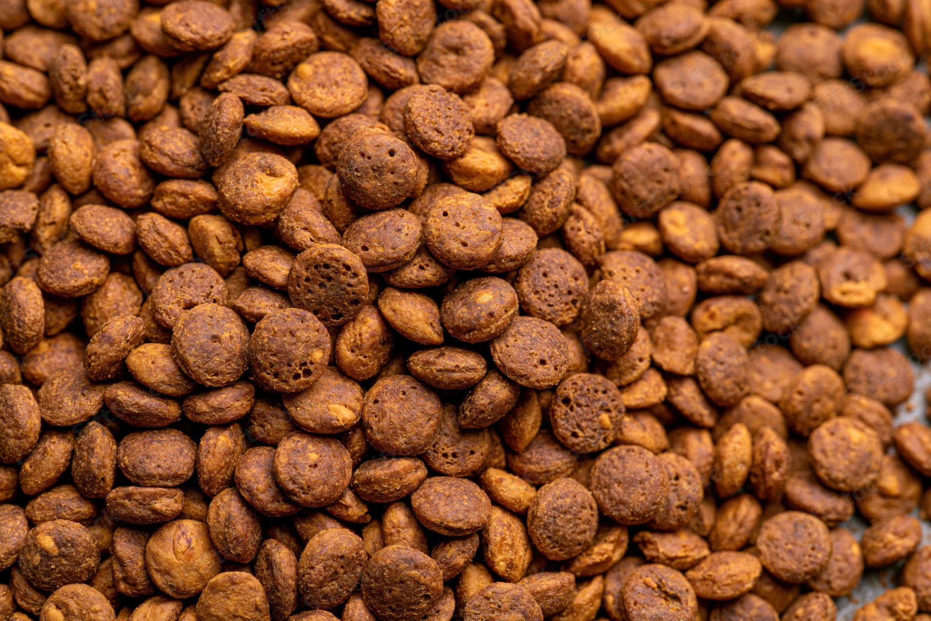 Close-up of dry pet food kibble pieces filling the frame