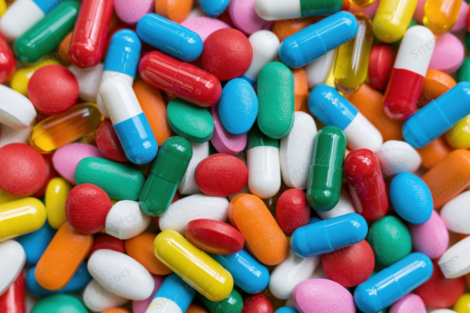 Closeup of colorful pharmaceutical pills and capsules scattered in a pile